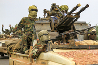 Fighters ride in a vehicle moving in a military convoy accompanying the governor of Sudan's Darfur State on Aug. 30, 2023.